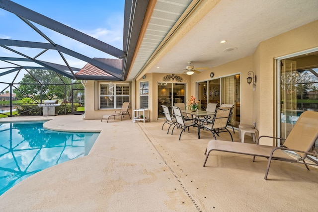 view of pool featuring a patio, ceiling fan, a lanai, and grilling area