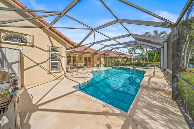 view of pool with ceiling fan, a lanai, and a patio