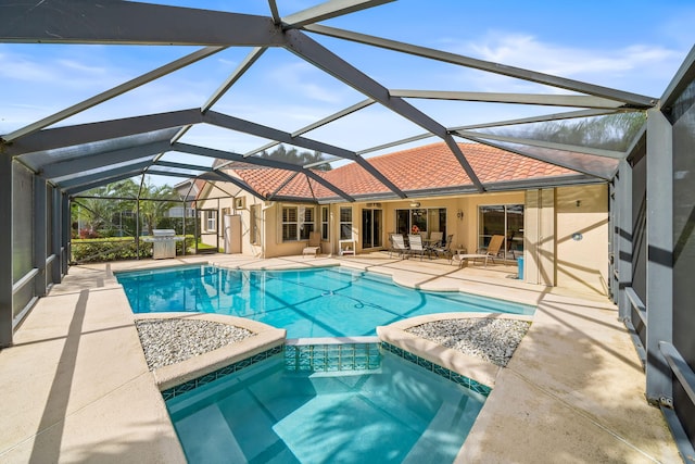 view of swimming pool with a grill, a patio area, a lanai, and ceiling fan