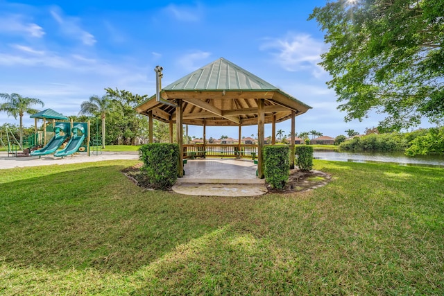 exterior space featuring a gazebo, a playground, and a water view