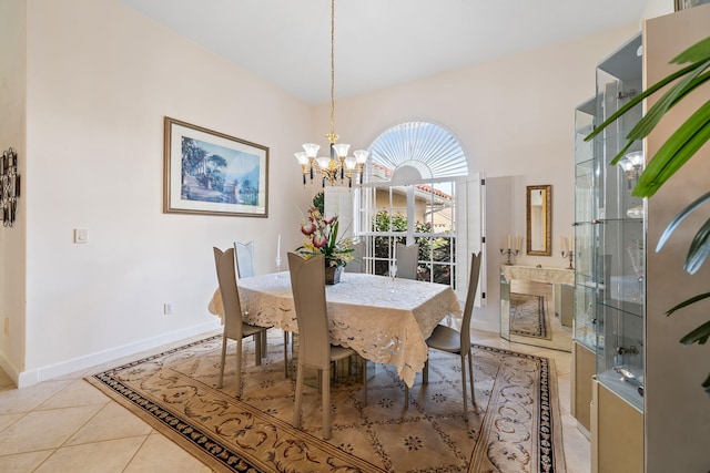 dining area featuring light tile patterned floors and an inviting chandelier