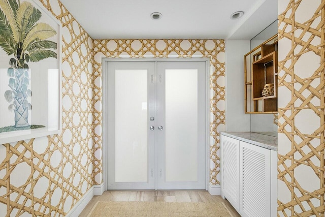 interior space with french doors, baseboards, and wood finished floors