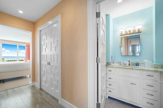 bathroom with vanity and hardwood / wood-style flooring