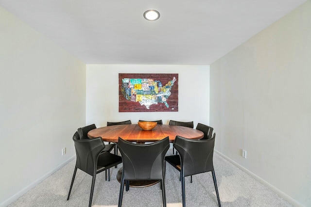 dining area featuring light colored carpet