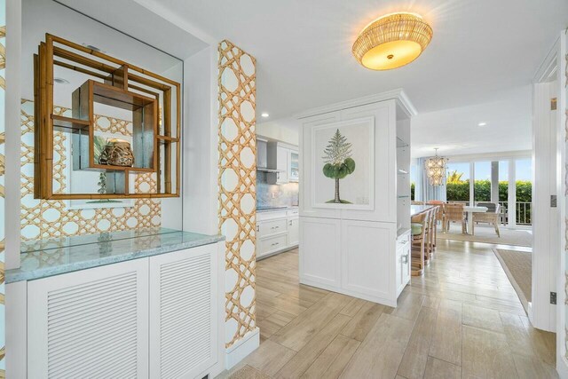 dining area featuring light hardwood / wood-style floors and an inviting chandelier