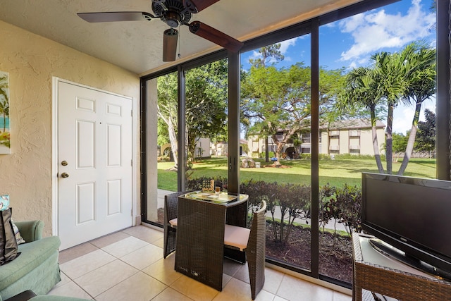 sunroom / solarium featuring ceiling fan