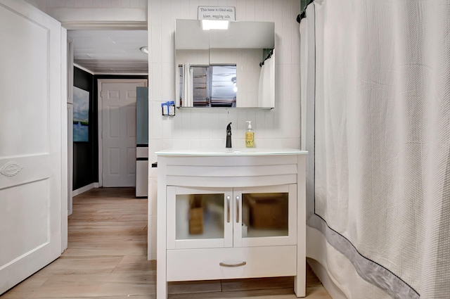 bathroom featuring wood-type flooring, vanity, and curtained shower