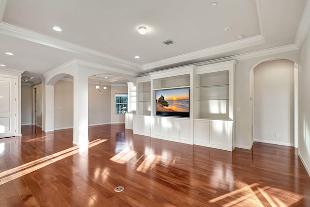 unfurnished living room featuring a raised ceiling, dark hardwood / wood-style flooring, and crown molding