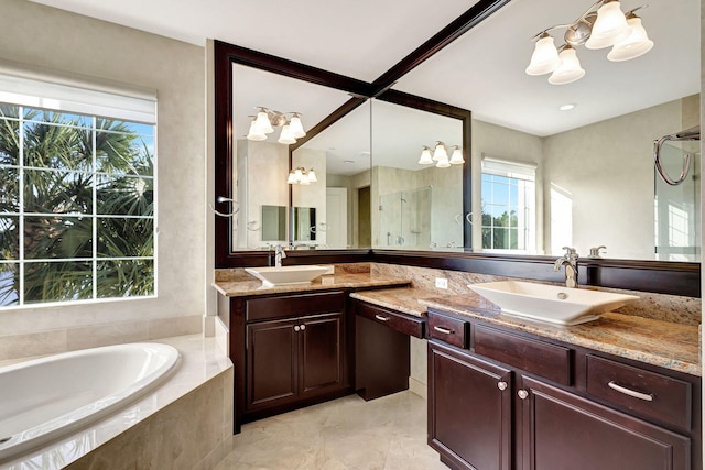 bathroom with plus walk in shower, vanity, and an inviting chandelier