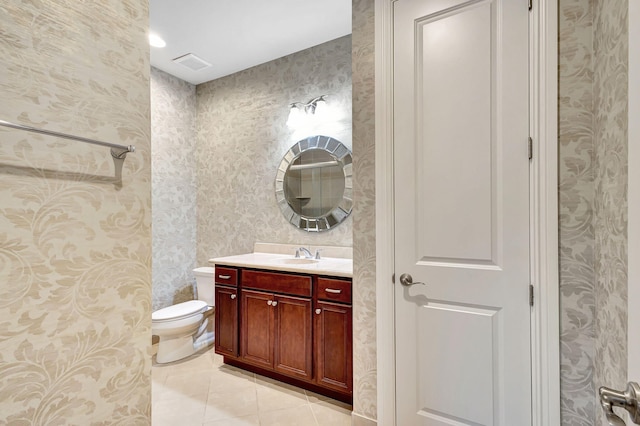 bathroom featuring tile patterned floors, vanity, and toilet