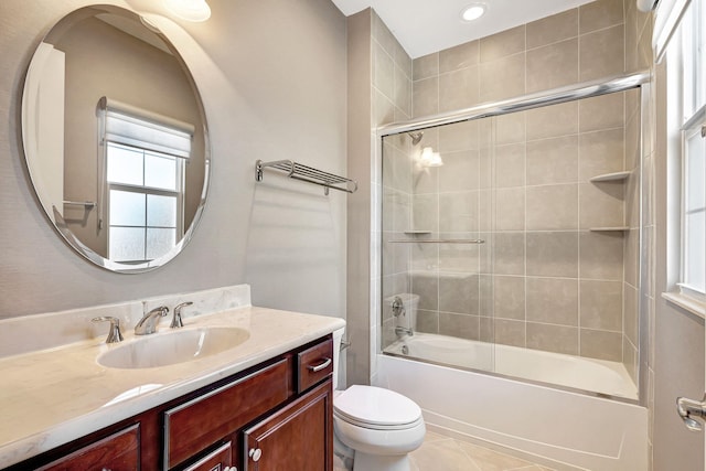 full bathroom with tile patterned flooring, vanity, toilet, and bath / shower combo with glass door