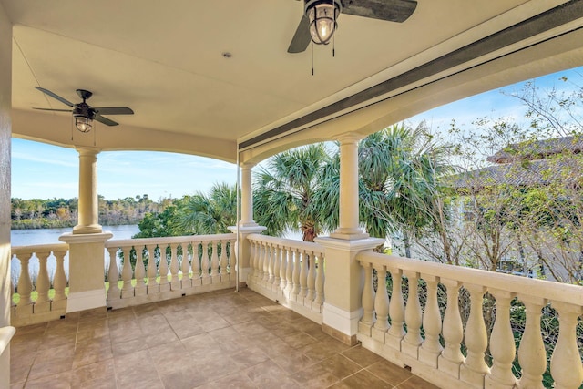 view of patio / terrace featuring ceiling fan and a water view