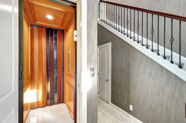 interior space featuring elevator and wooden ceiling