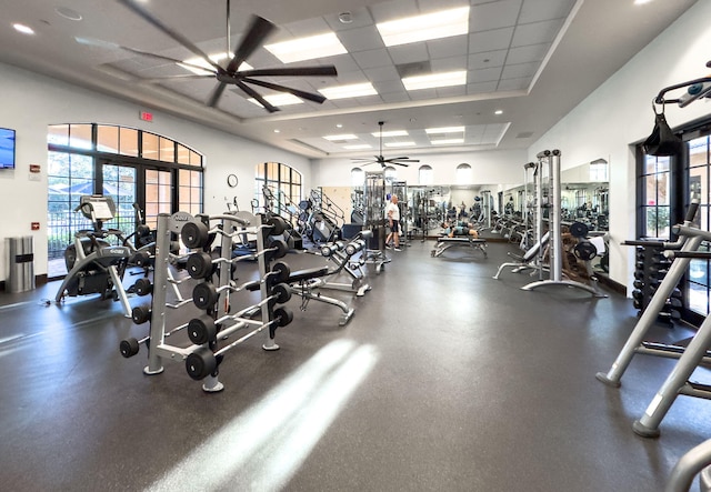 workout area with a paneled ceiling and ceiling fan