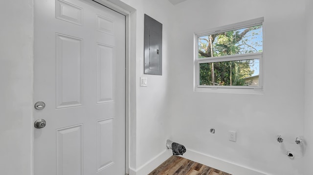 washroom featuring dark hardwood / wood-style flooring, electric panel, and electric dryer hookup