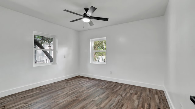 spare room with dark hardwood / wood-style floors and ceiling fan