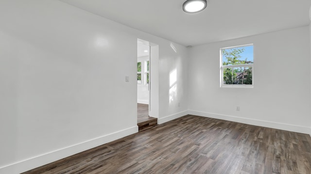 empty room with dark hardwood / wood-style floors