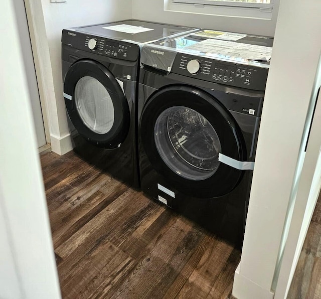 laundry area featuring independent washer and dryer and dark wood-type flooring