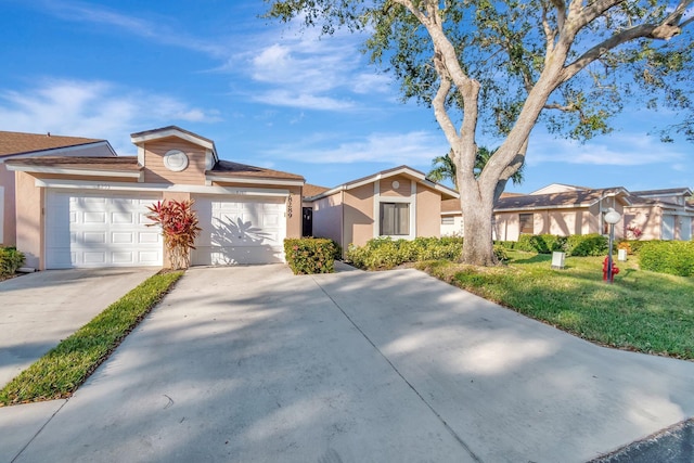 ranch-style home with a garage and a front lawn