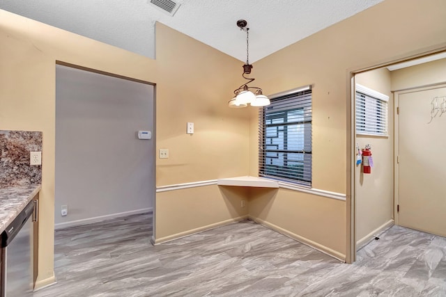 interior space with a textured ceiling and an inviting chandelier