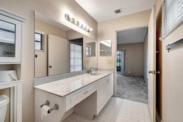 bathroom featuring tile patterned flooring, vanity, and toilet