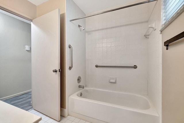 bathroom with tile patterned floors and shower / washtub combination