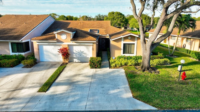 view of front facade featuring a front yard and a garage