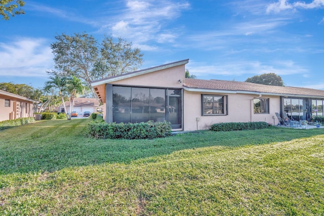 view of property exterior featuring a lawn and a sunroom