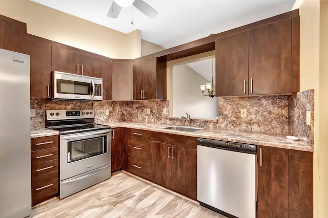 kitchen with backsplash, dark brown cabinetry, sink, and appliances with stainless steel finishes