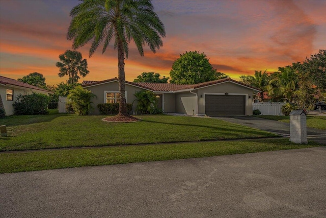 view of front facade with a lawn and a garage