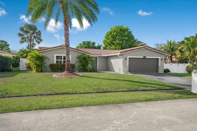 mediterranean / spanish-style home featuring a garage and a front lawn