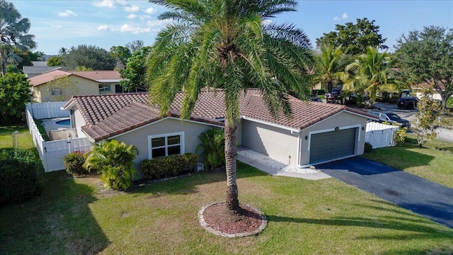 exterior space with a garage and a front lawn