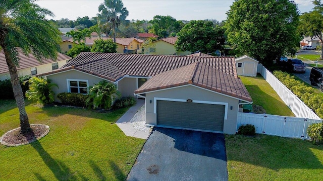 view of front of property with a garage and a front lawn