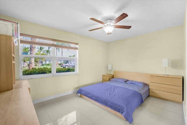 bedroom with tile patterned floors and ceiling fan