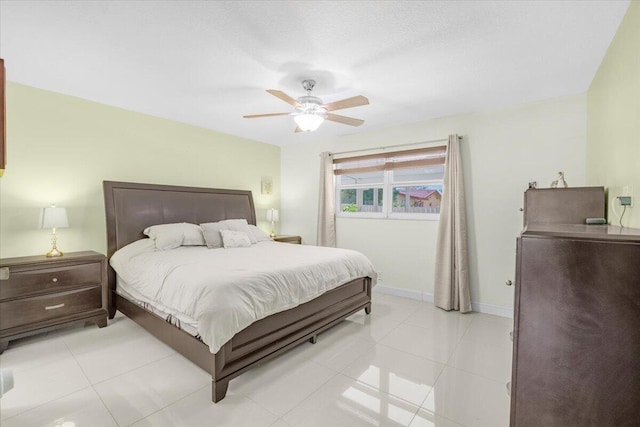 bedroom with ceiling fan and light tile patterned flooring