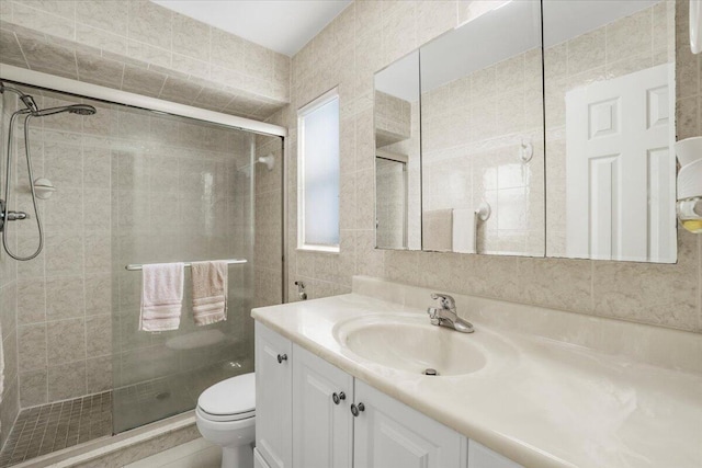 bathroom featuring vanity, toilet, and walk in shower