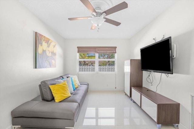 living room featuring ceiling fan and light tile patterned floors