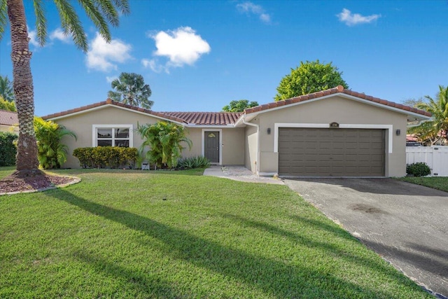 mediterranean / spanish house featuring a front lawn and a garage