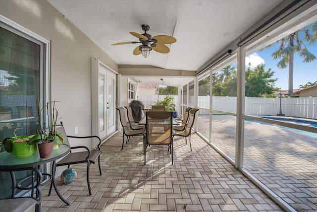 sunroom featuring ceiling fan