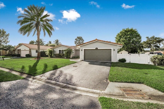 view of front of home with a garage and a front lawn