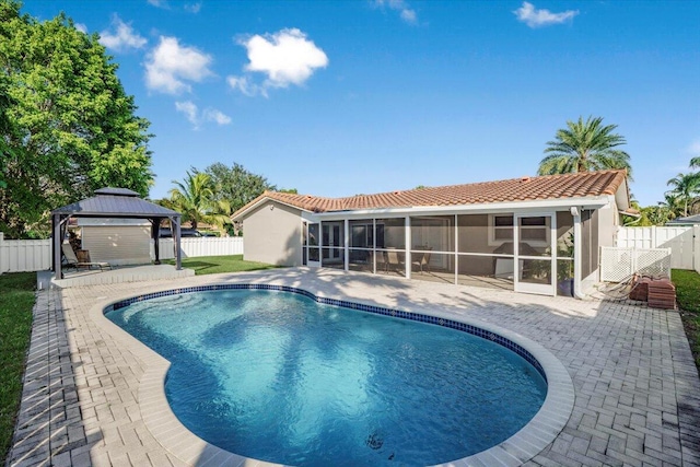 view of pool with a gazebo, a patio, and a sunroom