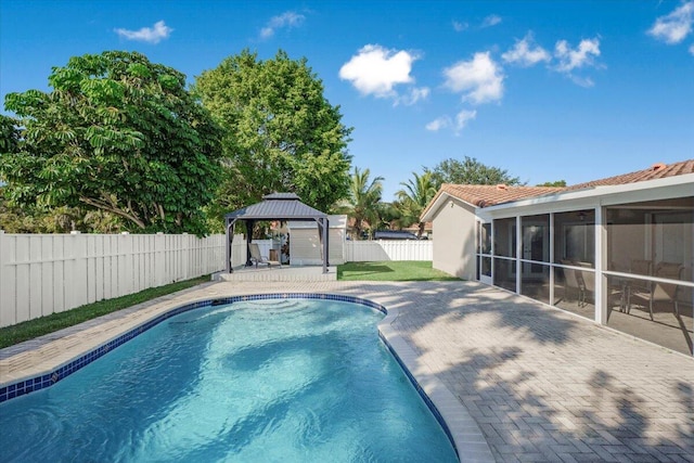 view of pool with a gazebo, a patio area, and a sunroom