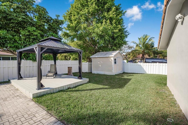 view of yard featuring a gazebo, a storage shed, and a wooden deck