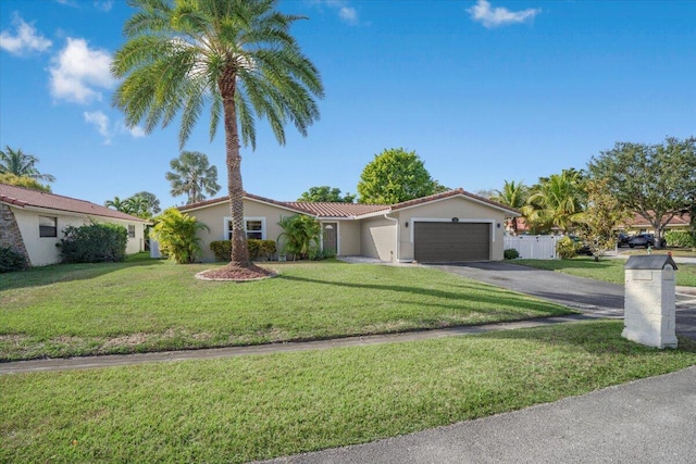 view of front of property with a front lawn and a garage