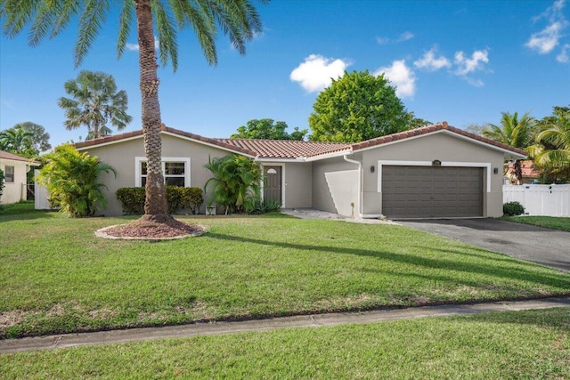 view of front of home featuring a front yard and a garage