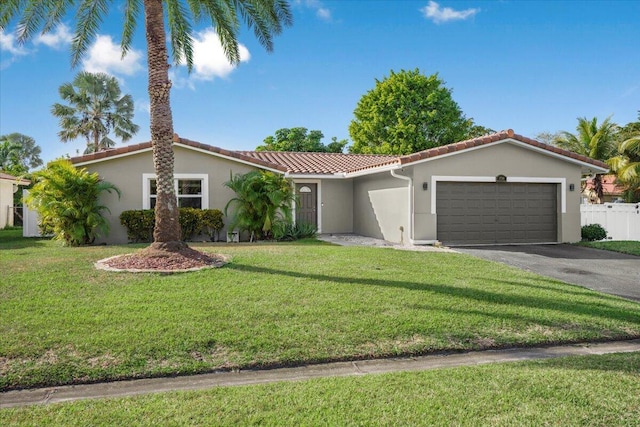 mediterranean / spanish-style house with a garage and a front yard