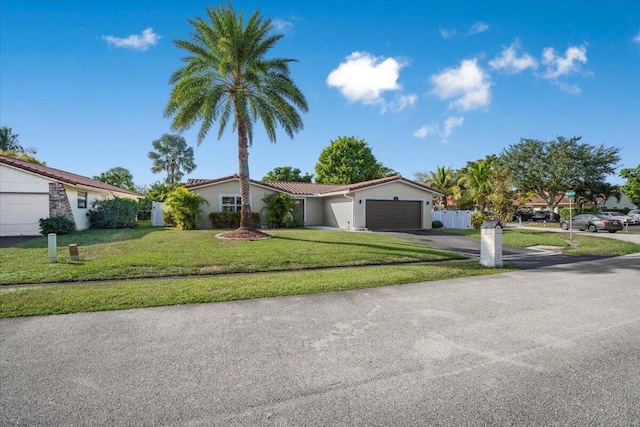 view of front of house featuring a garage and a front lawn