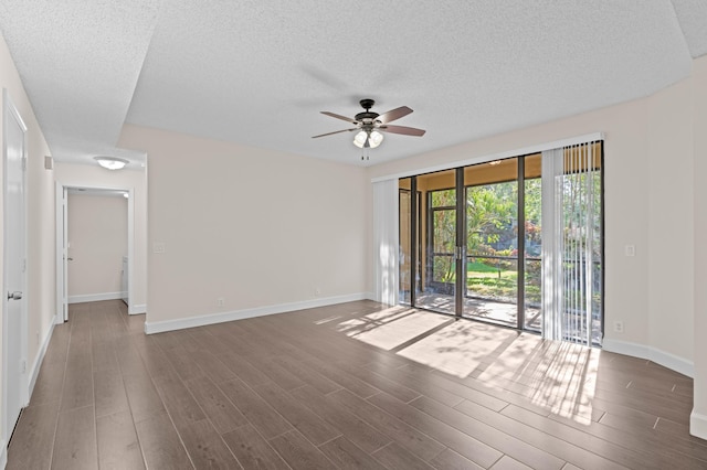 spare room featuring ceiling fan and dark wood-type flooring