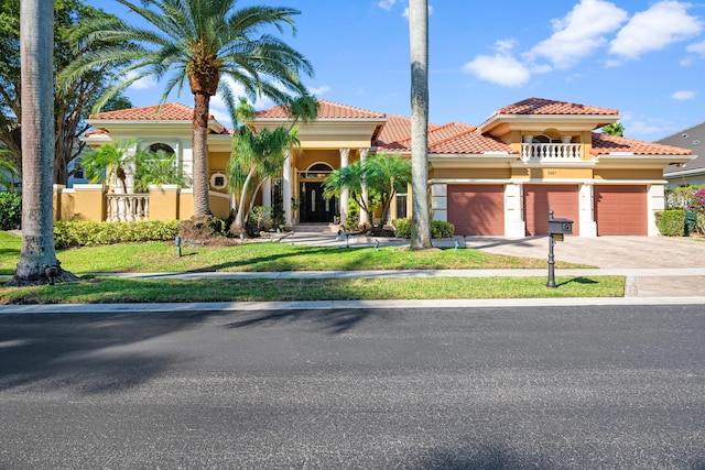 mediterranean / spanish home featuring a front yard