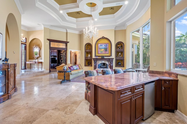 kitchen with hanging light fixtures, coffered ceiling, an inviting chandelier, crown molding, and a towering ceiling